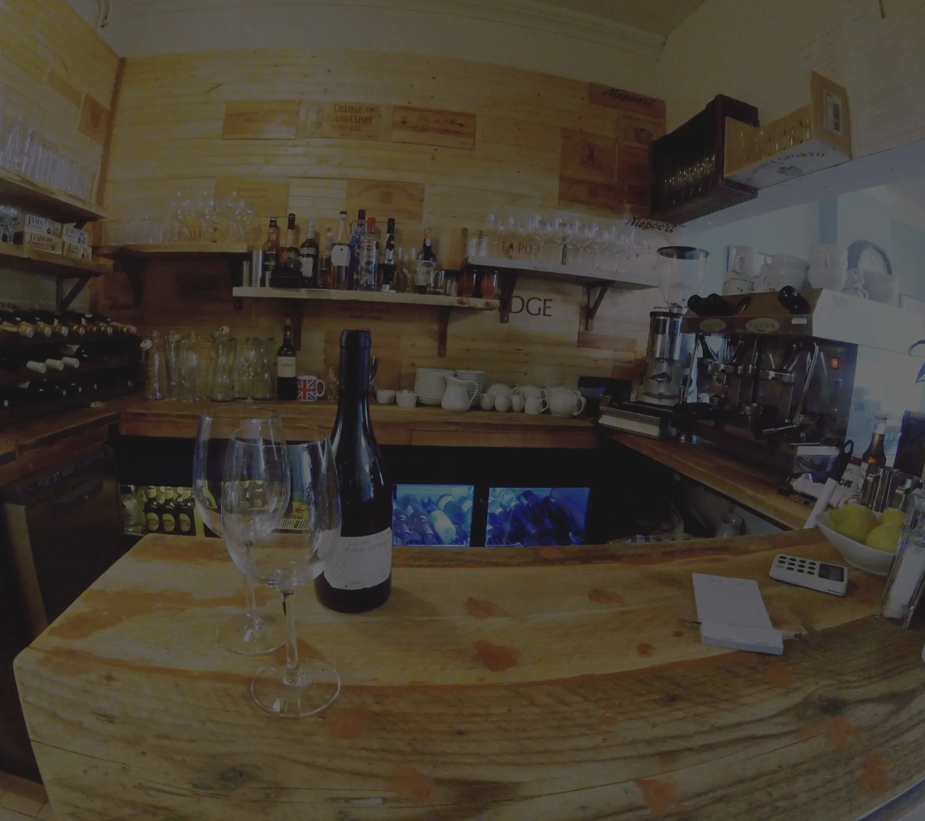 The bar at Chez Moi, with wine bottles and glasses ready for service